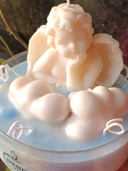A close-up of the angel's face in the angel and cloud jar candle.