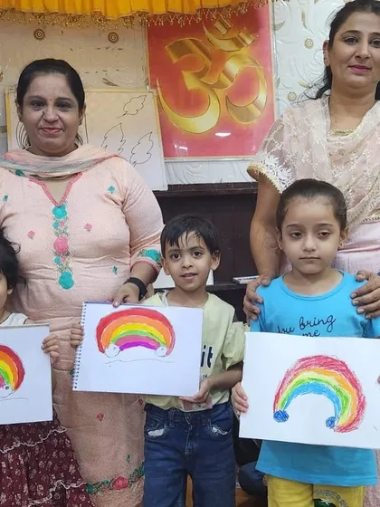 A group of our youngest students with their teachers and their finished rainbow art. It’s a picture of pure joy and pride.