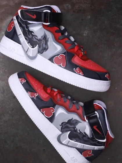 A top-down view of the Itachi custom AF1s, showing the artwork on both shoes.
