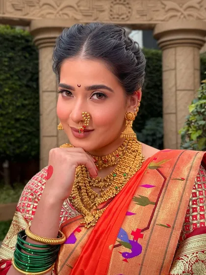 A close-up of my beautiful Maharashtrian bride. I focused on creating a warm, matte eye and lip to complement the traditional gold jewellery and Paithani saree, ensuring her natural radiance was the centerpiece.