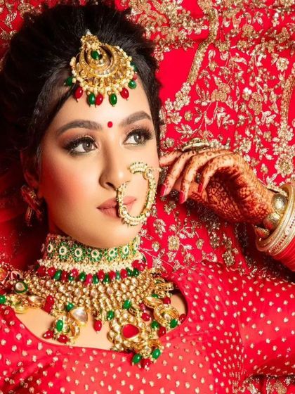 A stunning red and green bridal set. The choker features a mix of red and green stones, making it a versatile choice for traditional lehengas.