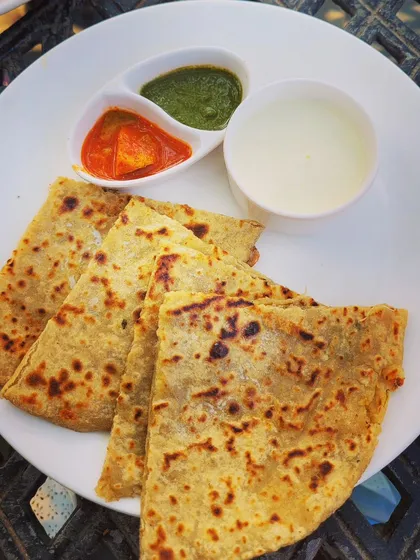 Nothing beats a plate of hot, homemade parathas. Here I have a variety of stuffed flatbreads including Aloo, Gobi, and Paneer paratha, served with fresh dahi, spicy mango achar, and green chutney.