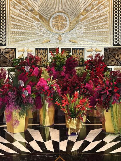 The rich textures of the florals stand out against the graphic patterns of the hotel's interior design.