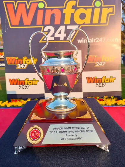 The T.B. Hanumantharaj Memorial Trophy, set against the backdrop of our sponsor Winfair247's branding, ensuring visibility throughout the race day's events.