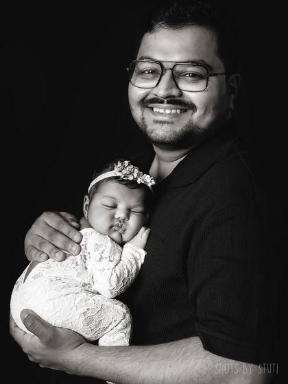 A proud father and his sleeping baby. This is a moment of pure peace and love.