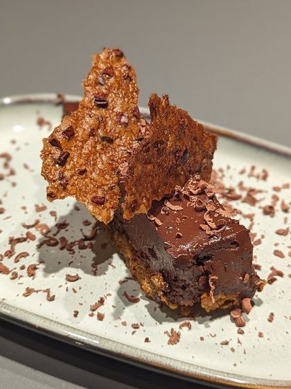 A decadent chocolate dessert from our Indian Craft Chocolate Festival kickoff dinner. This dish features a rich chocolate crémeux with a crispy cacao nib tuile, showcasing the versatility of cacao in both texture and flavor.