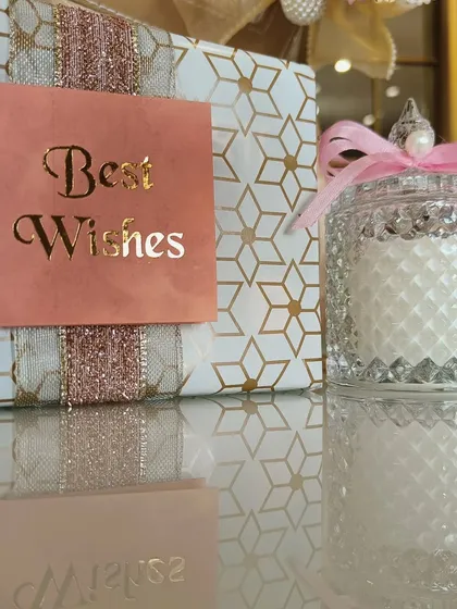 Cookies, candles, and the bestest wishes. This simple and sweet gift combo, featuring a "Best Wishes" box and a crystal-cut glass candle, is a perfect budget-friendly favor.