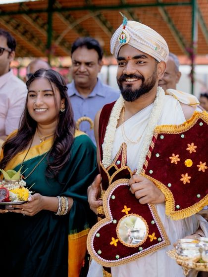 The groom stands with his sister during a pre-wedding ritual, showcasing the important role of family members throughout the wedding events.