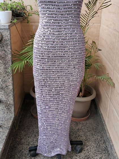 The full length of our sequined crochet cocktail dress, showing its elegant silhouette. This piece is designed to hug the body gracefully, creating a stunning, glamorous look.