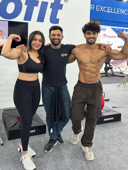 Posing with fellow fitness professionals at the Aerofit booth during the IHFF expo.