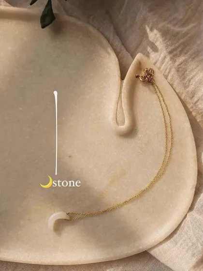The 'ádhva' half-moon pendant in white moonstone. If you feel unlucky in love, this stone can help by attracting abundance, good fortune, and the energy of new beginnings.
