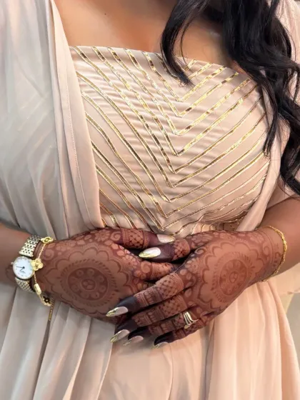 A lovely shot of her hands, adorned with beautiful henna and accessories.