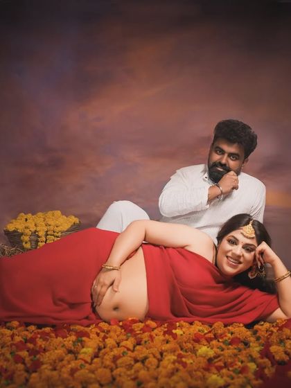 A royal portrait. This composition, with the mother reclining on a bed of flowers and her partner looking on, has the feel of a classical Indian painting, full of richness and emotion.