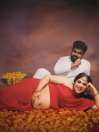 A royal portrait. This composition, with the mother reclining on a bed of flowers and her partner looking on, has the feel of a classical Indian painting, full of richness and emotion.