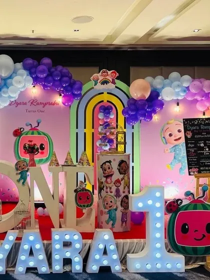 Bringing beloved characters to life is a joy. This vibrant Cocomelon first birthday party features custom character cutouts, a rainbow arch backdrop, and large marquee letters, creating a playful world for the little one and their friends.