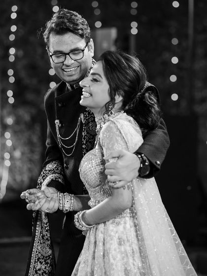 A happy black and white photo of the couple dancing together, lost in the moment.