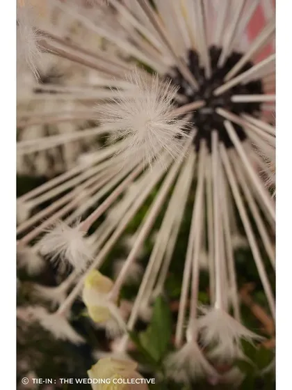 Our commitment to craftsmanship is seen in details like these handmade dandelions for the 'Midsummer Dream' theme. Each element is meticulously created by our in-house team to bring a unique, fantastical vision to life.