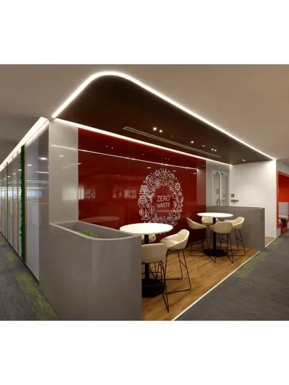 A perspective view of a collaborative corner within the ICICI Bank office, highlighting the "Zero Waste" graphic on the red glass wall. This detail shows how we integrate a company's values directly into the physical workspace design.