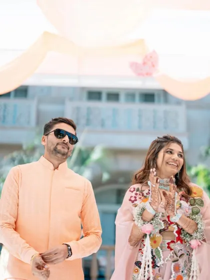 A happy couple at their Haldi ceremony. The bride's hair is styled in a simple yet beautiful way that complements her natural beauty.