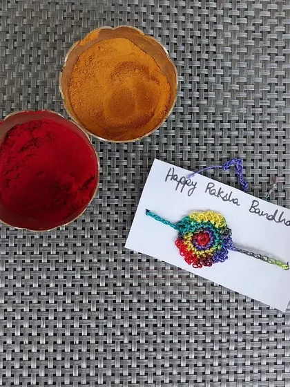 A vibrant, multicolored rainbow rakhi.