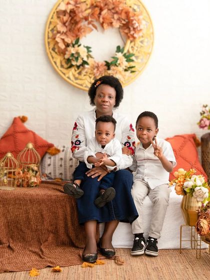 A happy family moment. The older brother's peace sign adds a touch of fun and personality to this lovely family portrait.