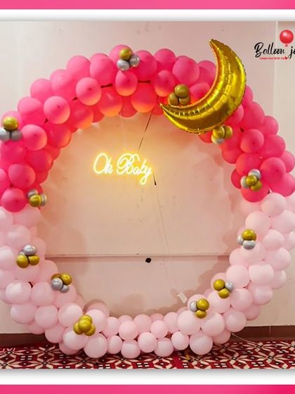 Oh baby! This gorgeous circular balloon arch in shades of bright pink and soft pink is perfect for a baby shower. The 'Oh Baby' neon sign and crescent moon foil balloon add a trendy and magical touch.