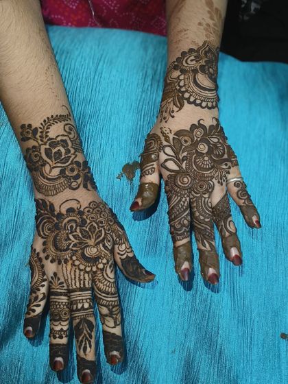 Both hands featuring the lotus motif, creating a symmetrical and balanced bridal look.
