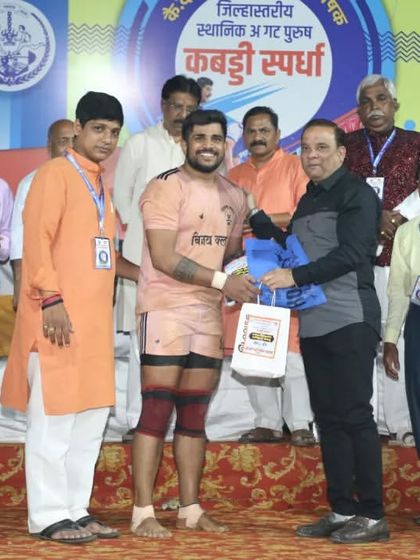 Vijay Divekar being felicitated on stage for his match-winning performance.