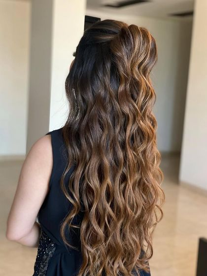 A half-tie look with beautiful, defined waves. The highlights in the hair really enhance the texture and dimension of the style.