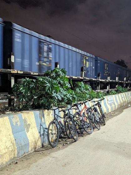A perfectly timed moment. We stacked our cycles to watch a bright blue freight train pass by under a magnificent moon during our ride to Horamavu.