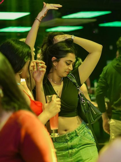 A guest dancing in the green light.