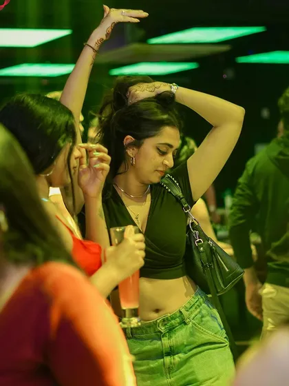 A guest dancing in the green light.