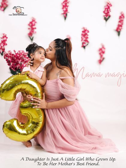 "Mama Magic" in action. A mother gives her daughter a loving kiss on the forehead during her third birthday photoshoot, holding a large number '3' balloon to mark the special occasion.