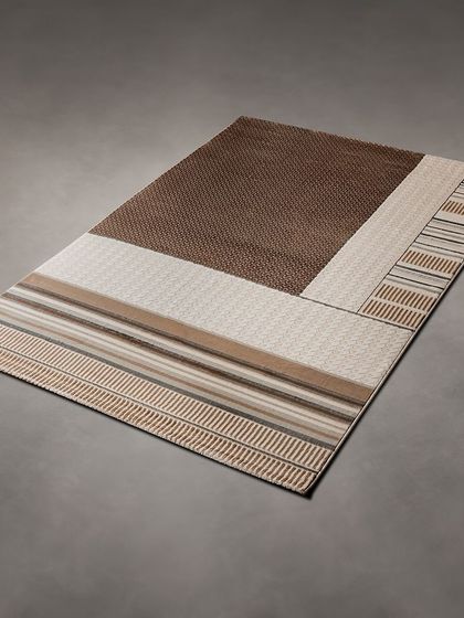 This rug has a more traditional feel with its striped and textured patterns in neutral brown and beige tones. It's a versatile piece that adds warmth and texture to your floor.
