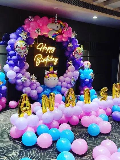 Another view of the unicorn-themed birthday setup, showing the full balloon arrangement and the name display.