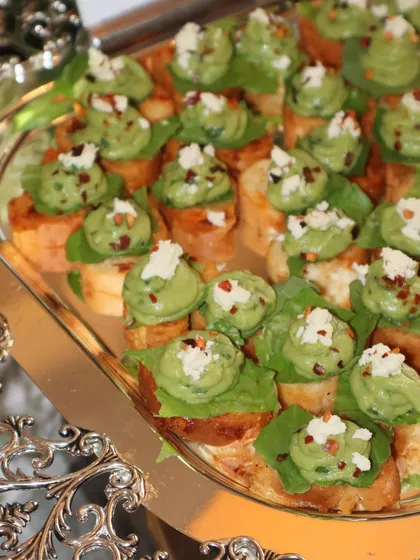 Another angle of our popular Avocado Mousse Crostini, showcasing the vibrant green and fresh toppings. It's a simple appetizer that always wows.