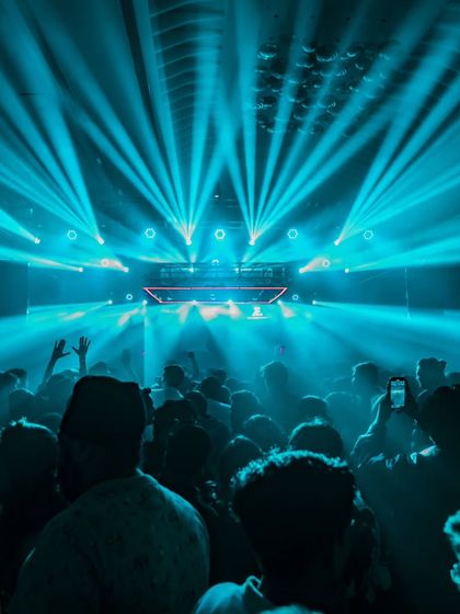 An ocean of people under a canopy of blue laser beams in Nashik. The production on this night was absolutely breathtaking.