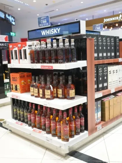 A detailed shot of a whisky aisle in a duty-free store. This type of image is useful for inventory documentation and marketing, highlighting the wide range of products available to customers.