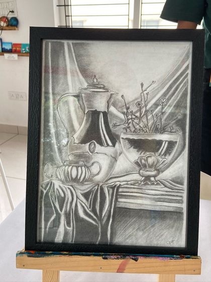 A stunning still life sketch created by a student in our short-term course. Notice the incredible detail in the reflections and fabric folds.