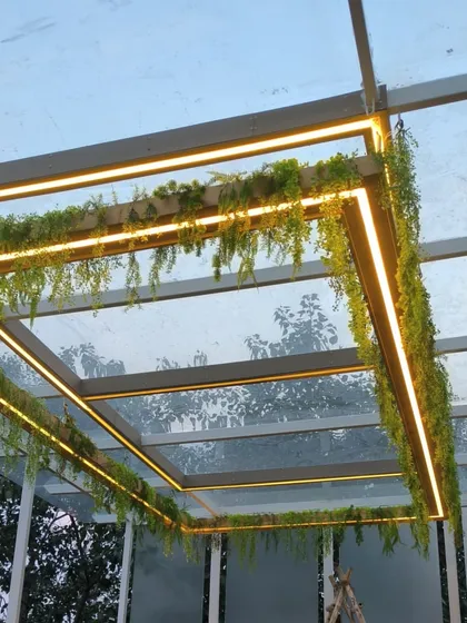 Another view of the lit pergola, showing how the light defines the structure.