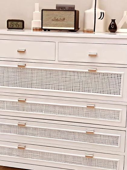 This is the matching chest of drawers for our white cane bedroom set. It features the same white duco finish and cane-front drawers, with modern rose gold handles to complete the look.