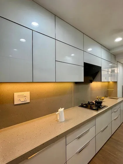 A straight laminate kitchen with a clean, minimalist design and ample counter space.