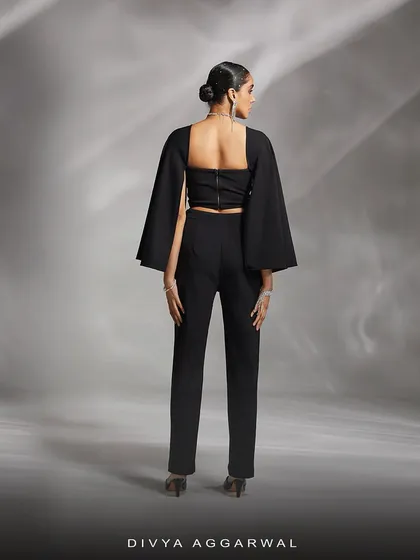 The back of our Ezra co-ord set, showing the clean lines of the sleek trousers and the unique silhouette of the detachable cape sleeves.