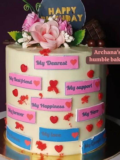A cake from a wife to her husband, covered in sweet messages like "My Best Friend," "My Support," and "My Hero."