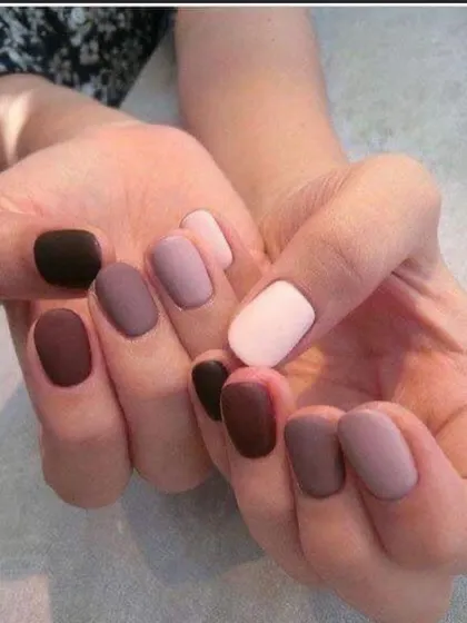 A trendy "gradient" manicure with a different shade of nude and brown on each nail, all with a modern matte finish.