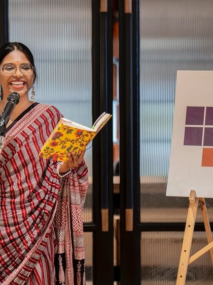 A poet in a beautiful saree, her expression full of life as she performs. Our Women's Day event celebrated fearless expression and boundless creativity.