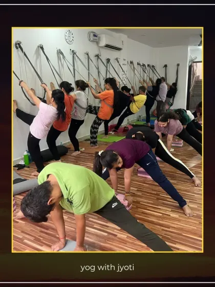 A class using wall ropes to assist with leg stretches, which helps in maintaining balance and achieving greater extension.