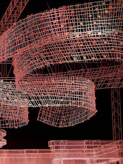 A dynamic shot of the ceiling installation, emphasizing its fluid, ribbon-like form. This structure was the key to transforming a simple lawn into an extraordinary wonderland.