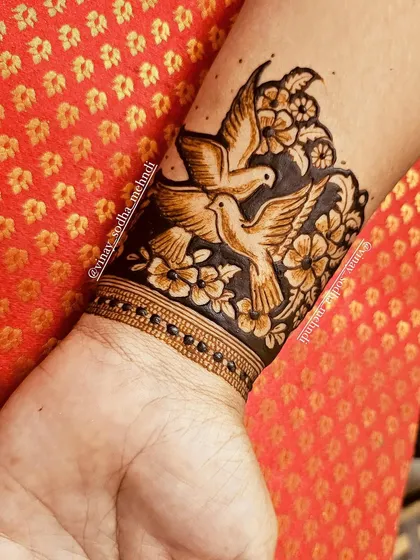 A stunning cuff design with two doves in flight, surrounded by flowers. This piece is a symbol of peace and love.
