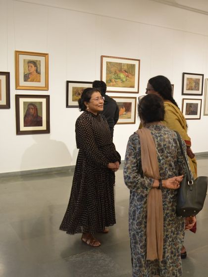Guests mingling at the preview night of the Vidya Bhushan show. These events are celebrations of the artist's legacy and a gathering for the art community.